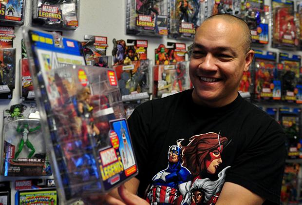 Michael DelDonno holds his most prized action figure, Warbird. DelDonnos collection takes up an entire room in his house, along with his garage. 