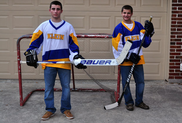 Tristan and Taylor Weinholzer gear up for the district ice hockey team. 