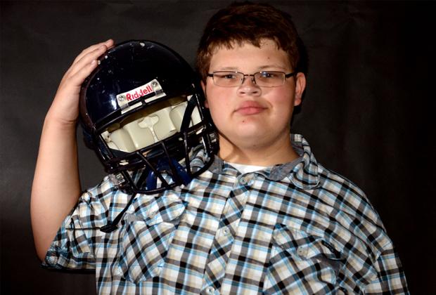 Freshman football player unable to play until a fitting helmet is found.