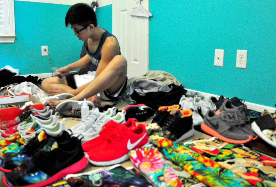 Senior James Le lays out his shoes and chooses which ones to wear for the day.