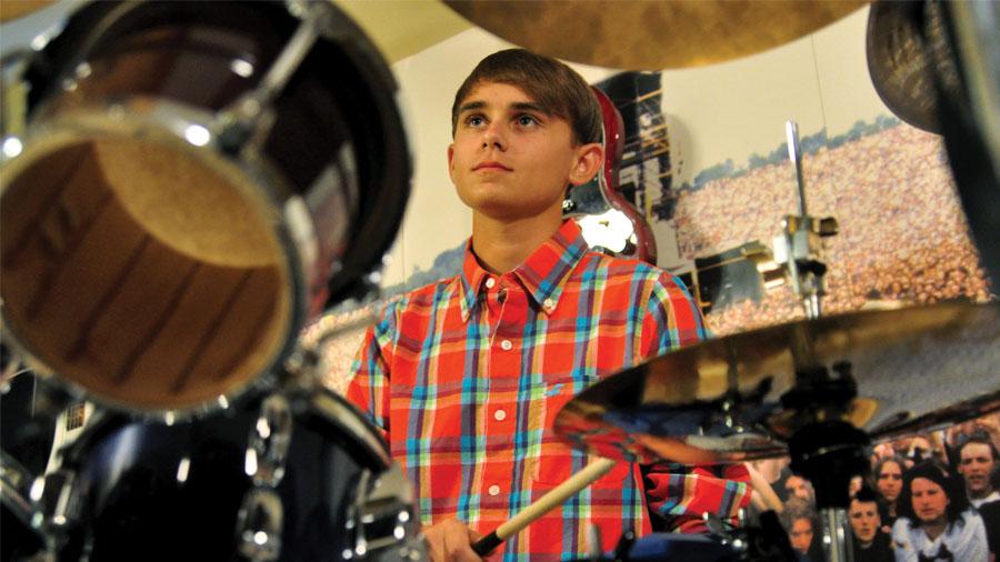 Sophomore Jackson Lightfoot creates a beat for a song on his drumset.  