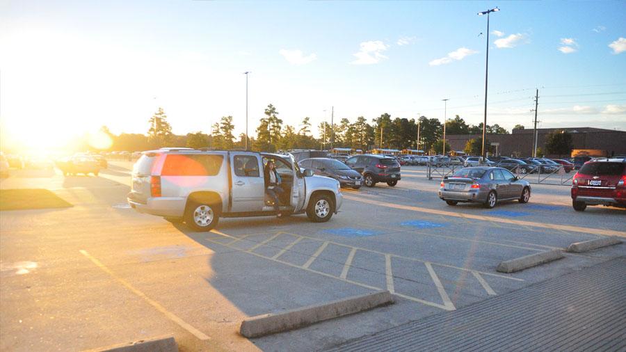 Student gets dropped off by parent in the student parking lot, instead of waiting in line.