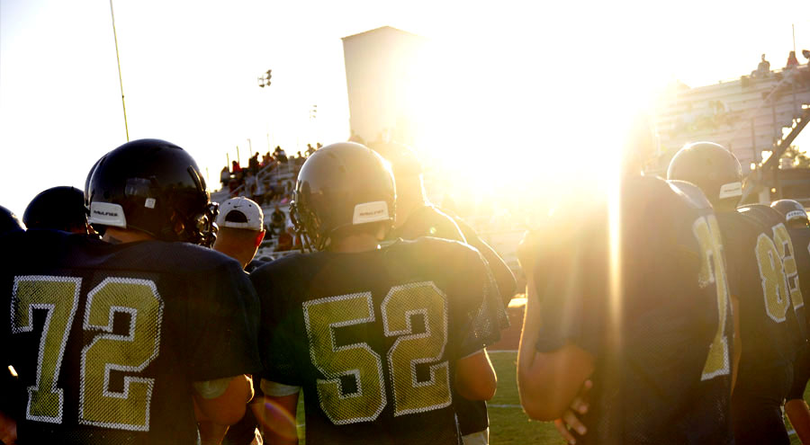 The+sun+begins+to+set+on+the+varsity+players+as+they+prepare+for+the+game.