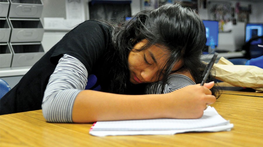 Senior Jasmin Tran dozes off in class while taking notes.