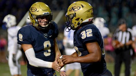 Seniors Nathaniel Edmonds and Justin Pratt shake hands at the homecoming game.