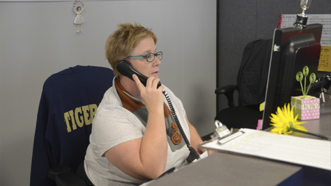 Attendance secretary Jean Franklin answers the phone.