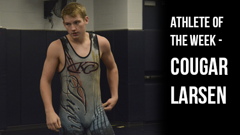 Senior Cougar Larsen prepares for a match with one of his teammates.