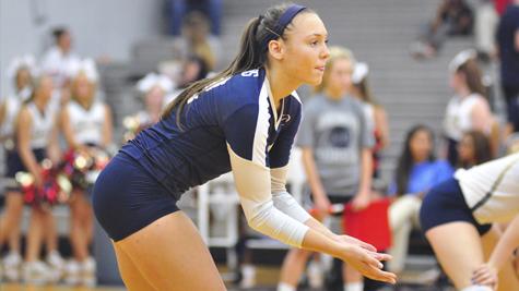 Senior Kelly Farina prepares to receive the ball during a varsity volleyball game.