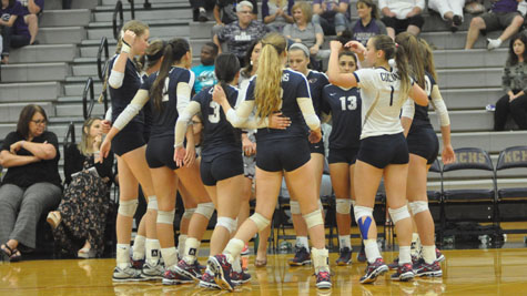 The Varsity Volleyball team celebrates after a victory.