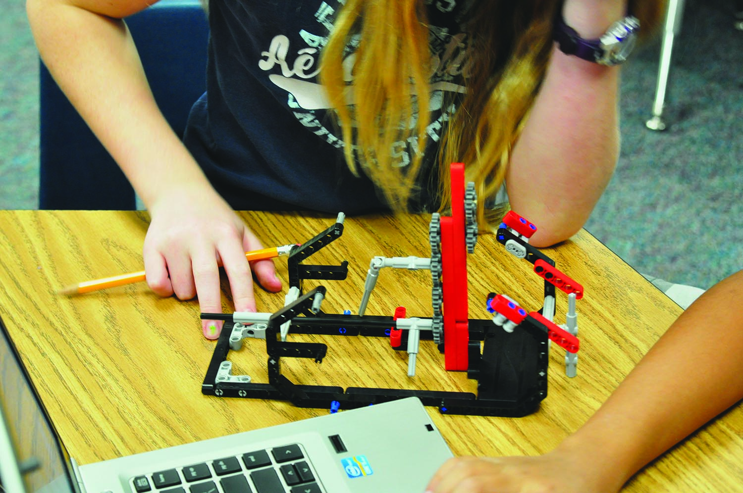 Students at Lemm Elementary participating in FLL are assigned a problem and have to think of an innovative way to solve it using a Lego robot.