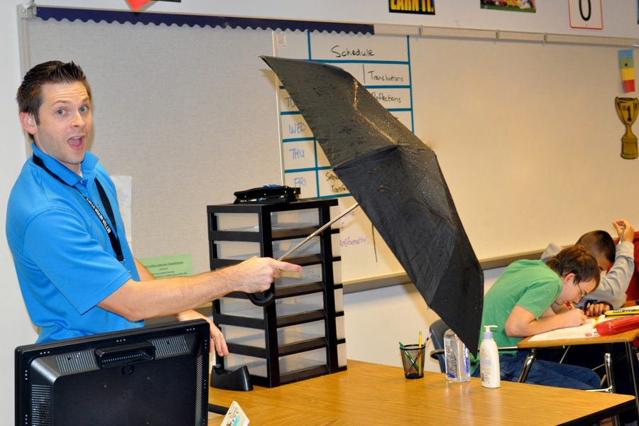 Former meteorologist Chad Garneau teaches his students math while holding an umbrella. “I decided to become a math teacher because I wanted to give back to the community by teaching kids the language of science, which is math,” Garneau said.