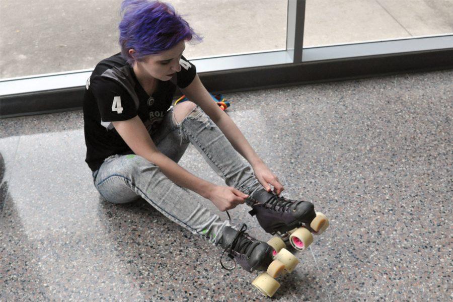 Senior Sydney Christofferson puts on her roller skates. My favorite thing about roller derby is the people because its inclusive and they accept everyone, Christofferson said. 