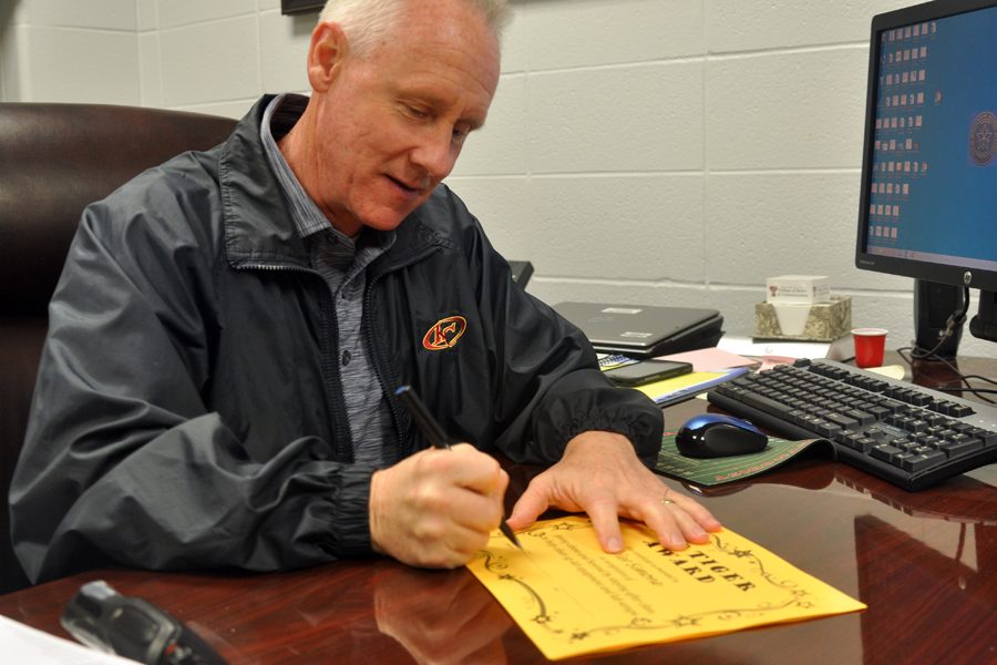Principal Randy Kirk signs the Top Tiger Award certificates for the January winners. [The award] shows [recognition for] students that are doing things that are important to Klein Collins, Kirk said.