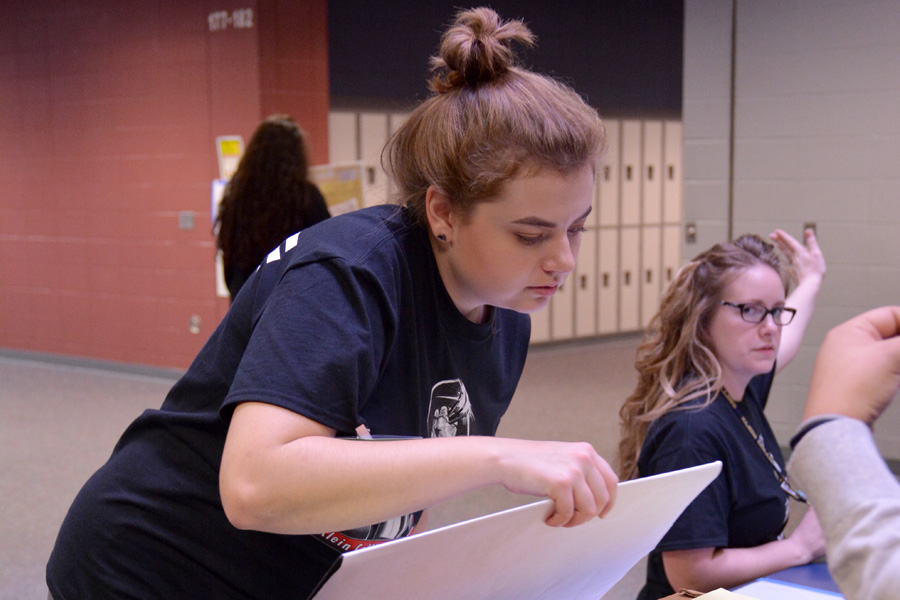 During the VASE competition, junior Emily Peropat guides contestants to the proper room for judging.