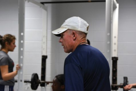 Girls Soccer coach Mark Pike tests the soccer players on how much weight they bench.