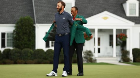 Last years winner, Tiger Woods, placed the coveted green jacket on Johnson.