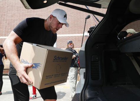 J.J. Watt, pictured above, places a box of relief supplies in the back of a vehicle on Monday, Aug. 27 2017 (Brett Coomer/Houston Chronicle via AP, Pool)
