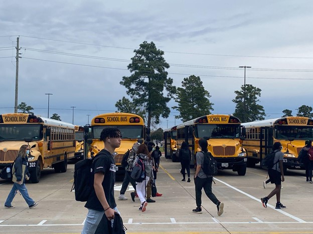 Students rushing into the Klein Collins bus lot right after the school bell rang.