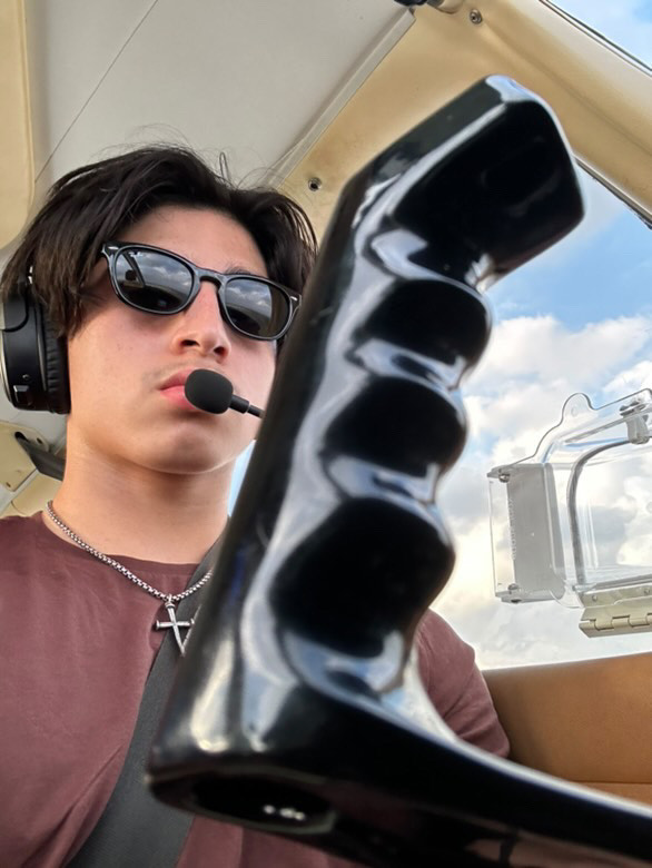 Behind the controls of an airplane, freshman Daniel Salazar practices maneuvers and earns flight hours to obtain his pilot license. 