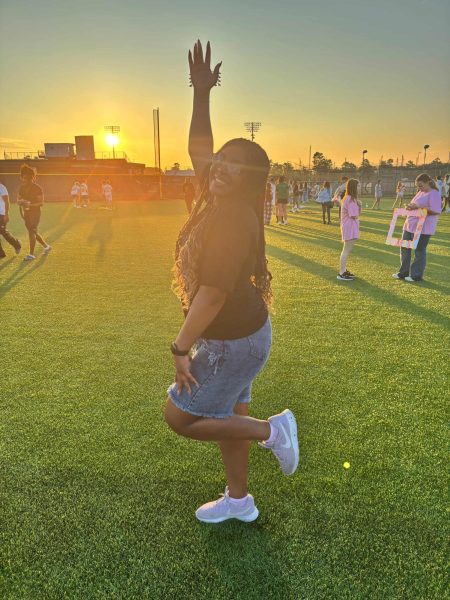 Enjoying the senior sunrise on the baseball field, senior Denesia Gibson dances her way across the field. 